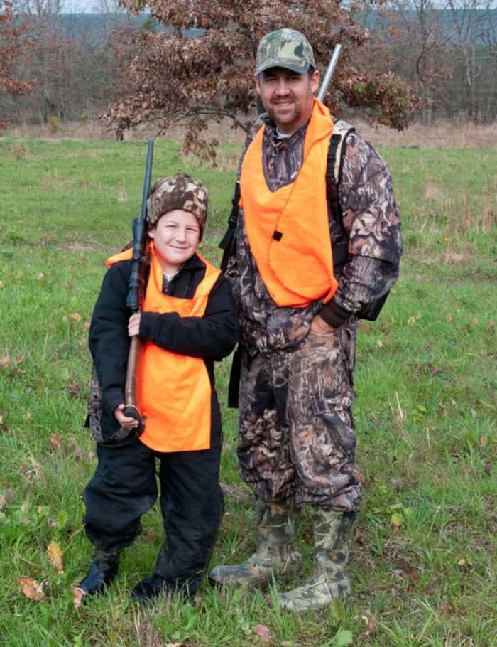 Father and Son Deer Hunters Wearing Orange Vests